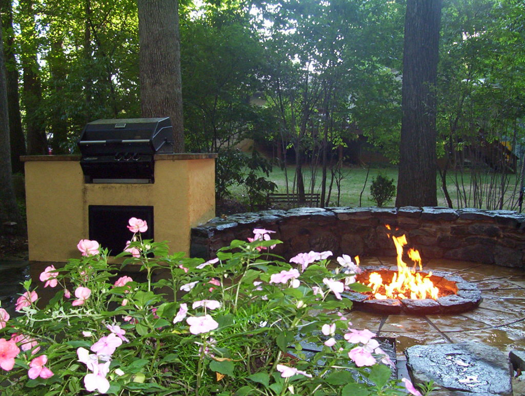 freshly built stone fire pit in a backyard