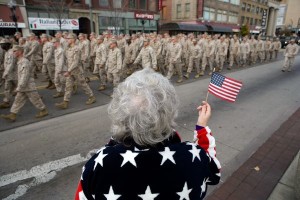 Old woman holding an American flag on veterans day