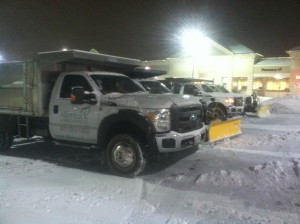 trucks preparing to plow snow on snowcovered streets