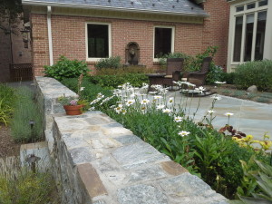 Stone steps and a stone fence with flowerbed located in Lieberman