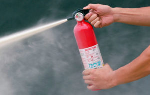 A man activating a fire extinguisher