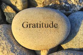 Gratitude written on top of a smooth stone