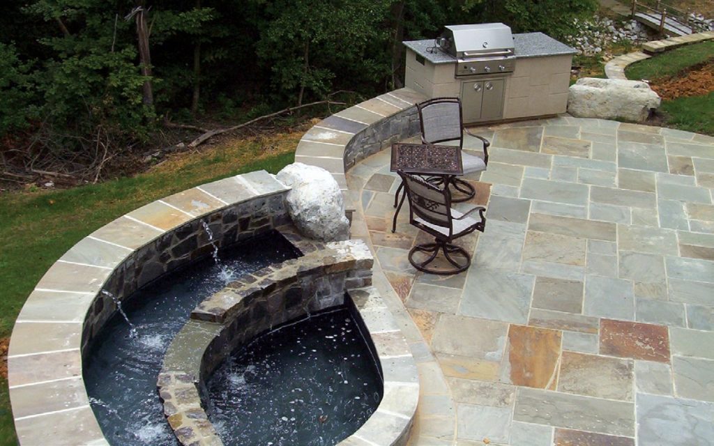 terrace waterfall created in stonework next to a new patio installation