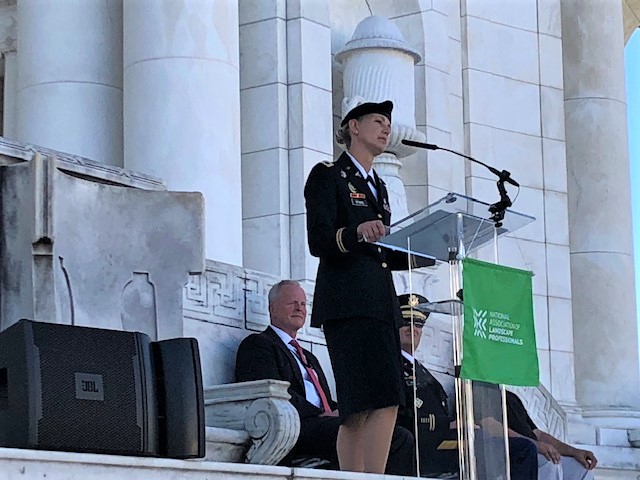 female Soldier speaking at a podium