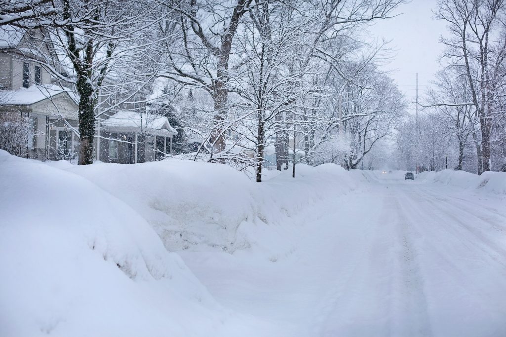 snow covered yards along a residential sheet