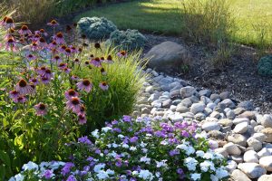 a graded rock drainage area installed as part of professional landscaping