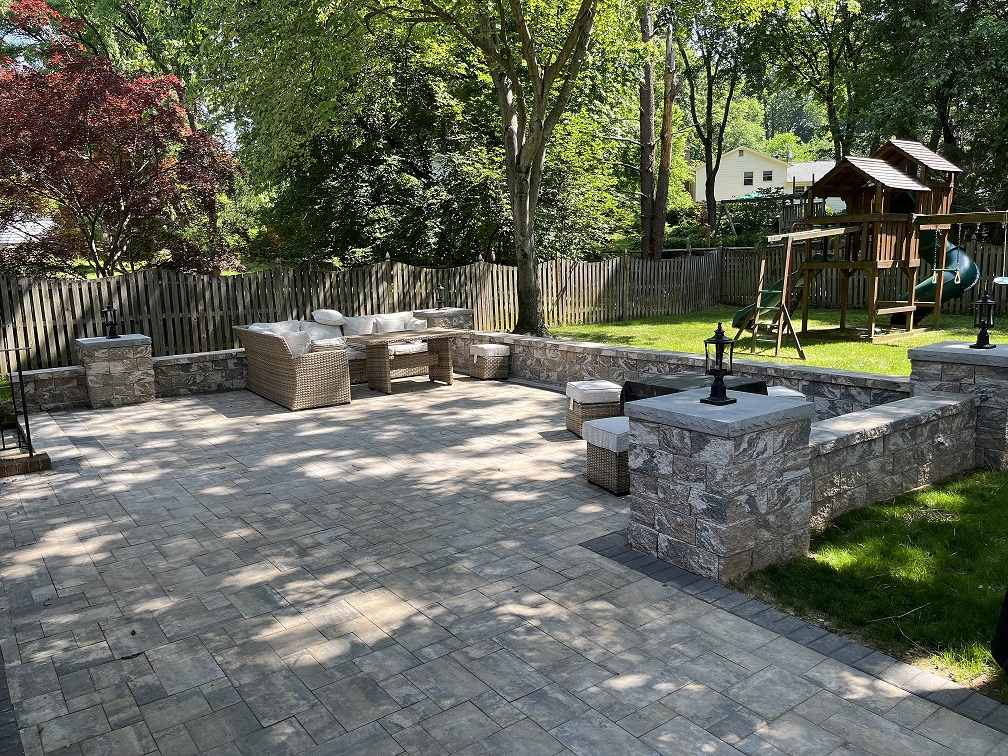 stone wall landscaping project with wicker patio furniture