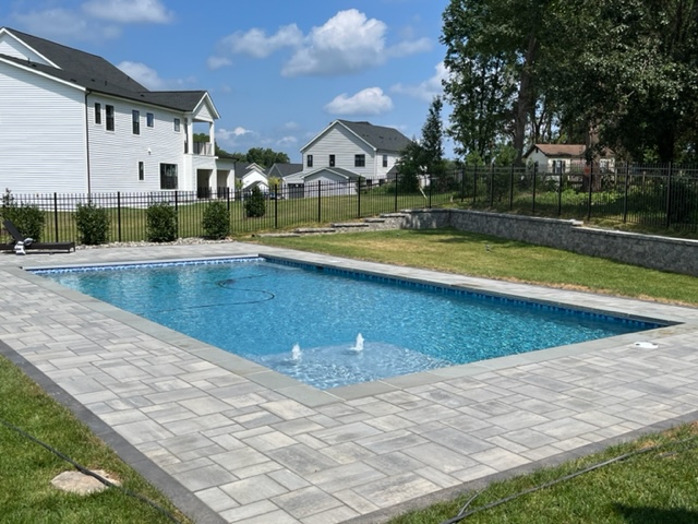 new swimming pool in a residential backyard