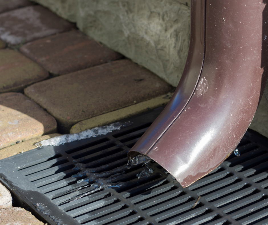 a downspout leading into a storm drain