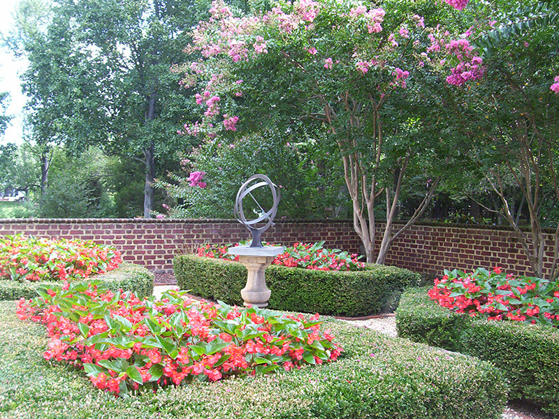 Landscaped Garden with trimmed bushes and flowers Landscaped Garden with trimmed bushes and flowers