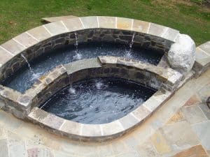 stone patio outdoor kitchen water feature